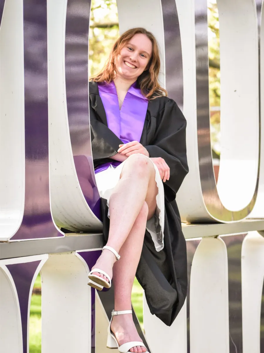 Graduate Assistant Erika smiling in graduation attire