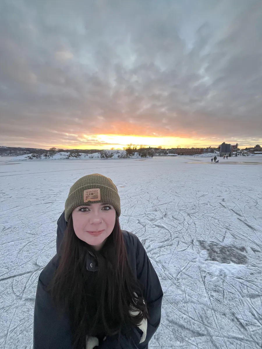 Graduate assistant Addi Pavlo smiling on frozen lake Superior