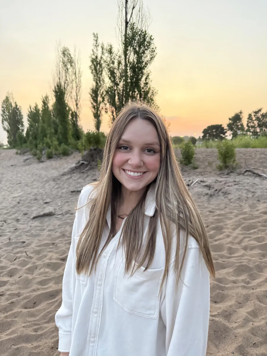 Graduate Assistant Jenna Wealton smiling at the beach