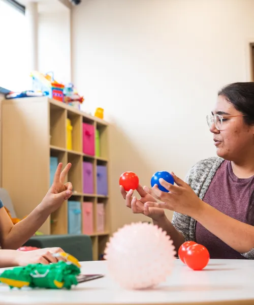 woman using applied behavior analysis therapy for a child