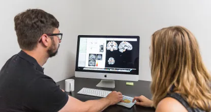 Student and professor looking at brain scans
