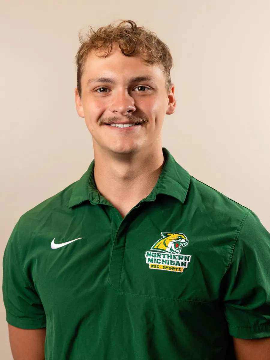 Headshot of Aaron Kozlow in green polo shirt