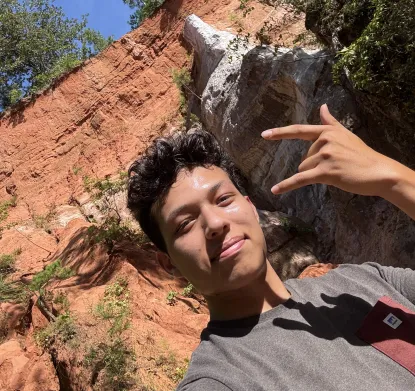 Own (fitness instructor in front of rock cliff) 