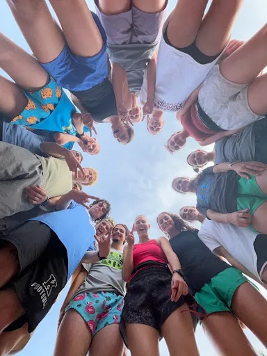Photo of group of students in circle looking down