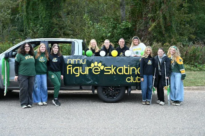 Figure skating team posing outside prior to Homecoming parade