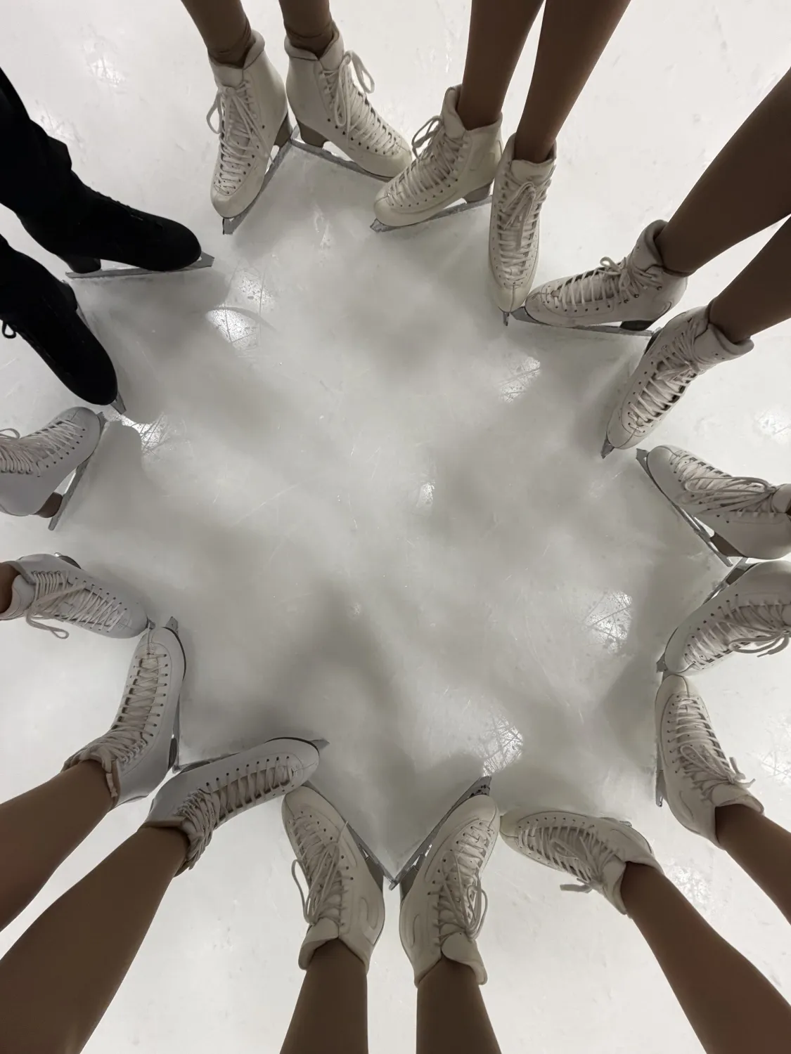 Pic of just skates on ice in artistic formation