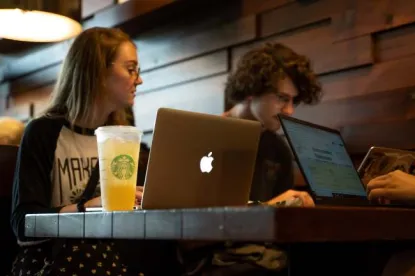 Students at Starbucks working on their laptops.