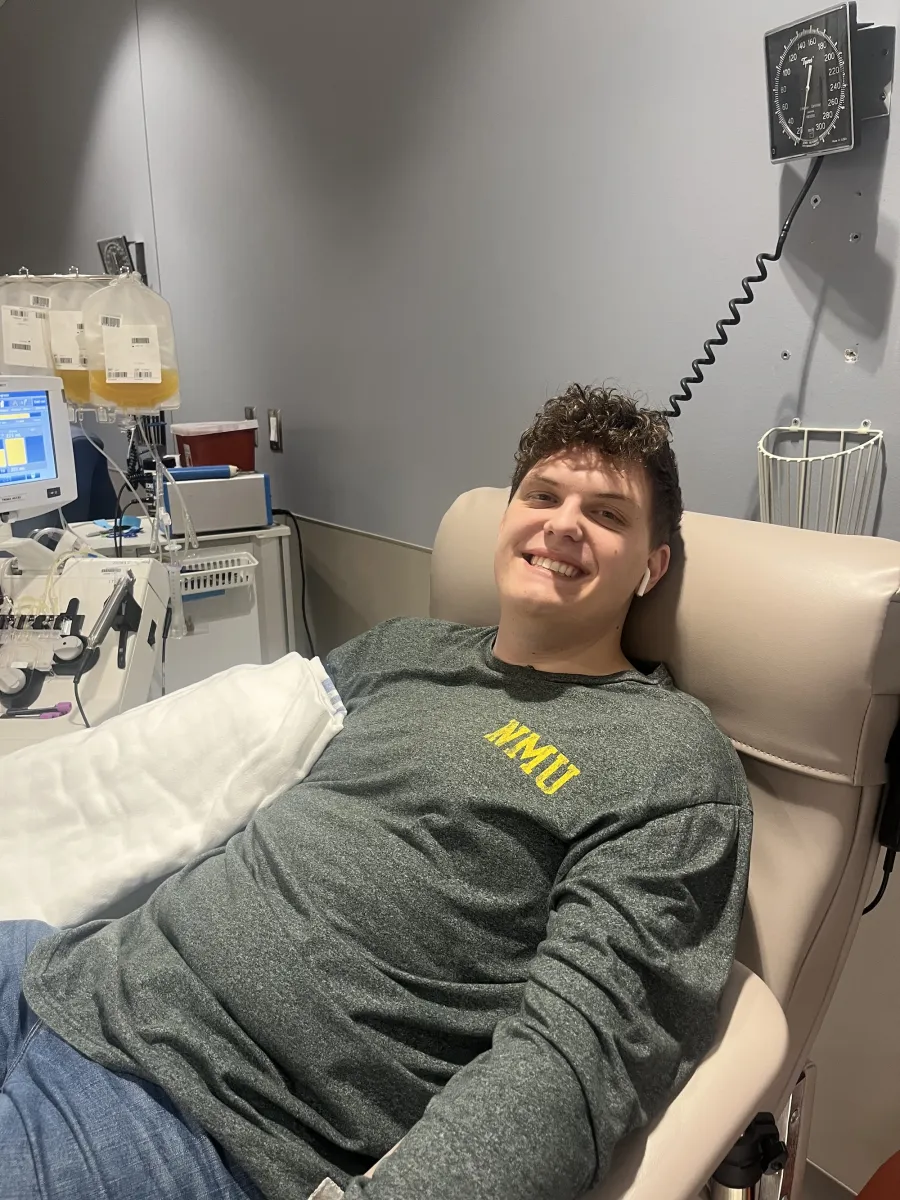 NMU alum giving blood at UP regional blood center