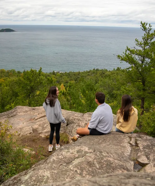 Students sitting on top of Sugarloaf Mountain.