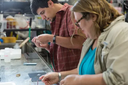 Student and faculty member working in the aquatics lab on NMU's campus