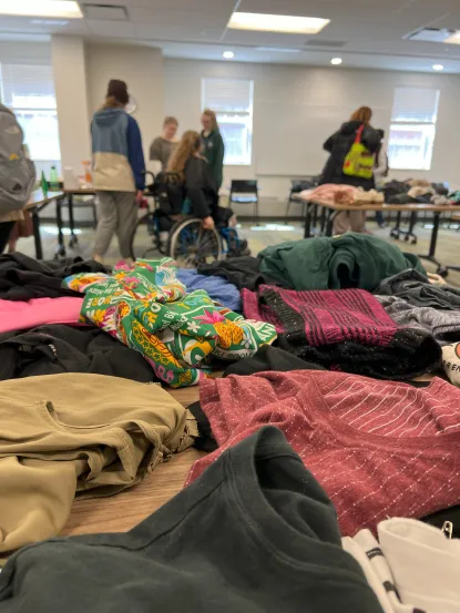 Students looking at clothing and other items at stuff swap