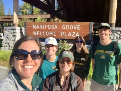 NMU team standing in front of Mariposa Grove Welcome Center