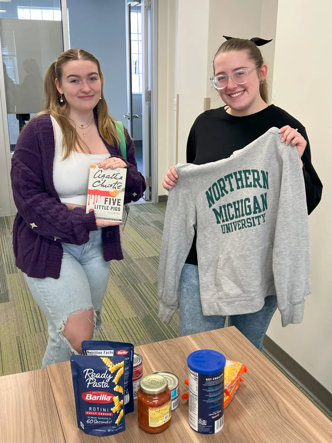 students holding things they picked up at stuff swap