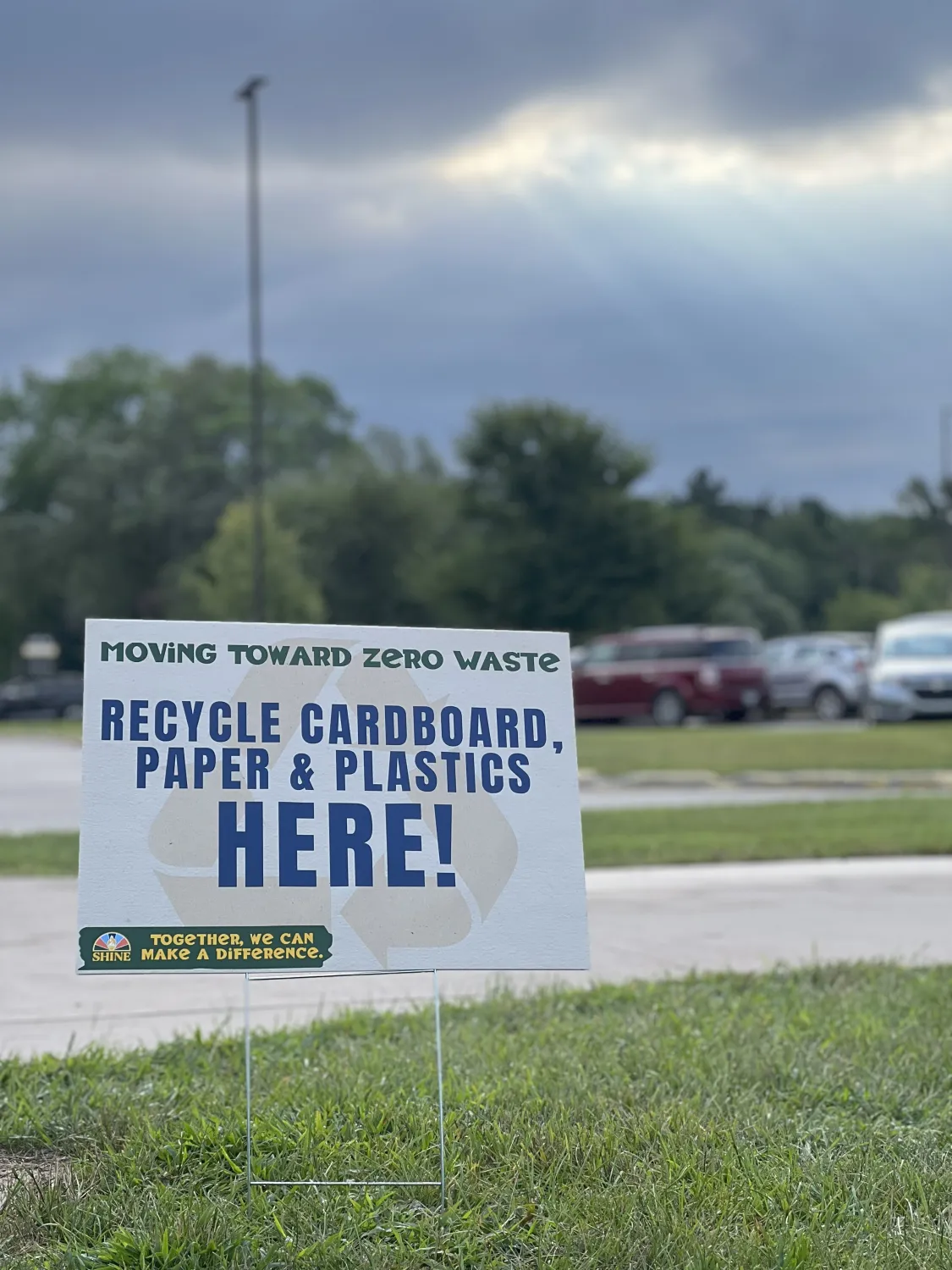 sign that says "recycle cardboard, paper & plastics here!"
