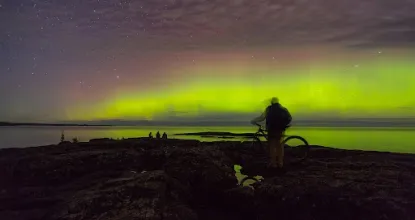 Northern Lights and student with bike