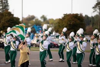NMU marching band performing at homecoming parade