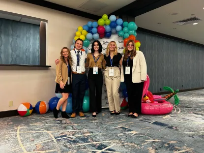 A student group poses for a group picture at a conference they presented their research at.