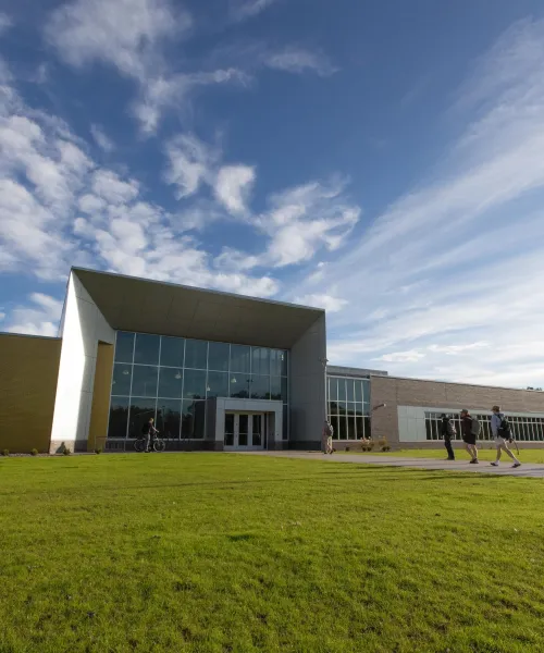 Students walk outside the Jacobetti Complex on NMU’s campus.