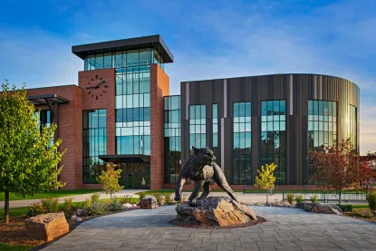 A photo of the John X. Jamrich building, featuring a wildcat statue outside