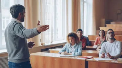 an instructor leads a lecture among students in a classroom