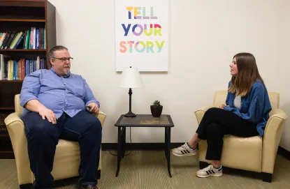 A social work student sits across from a patient