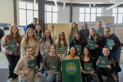 Students at Celebration holding logo posters 