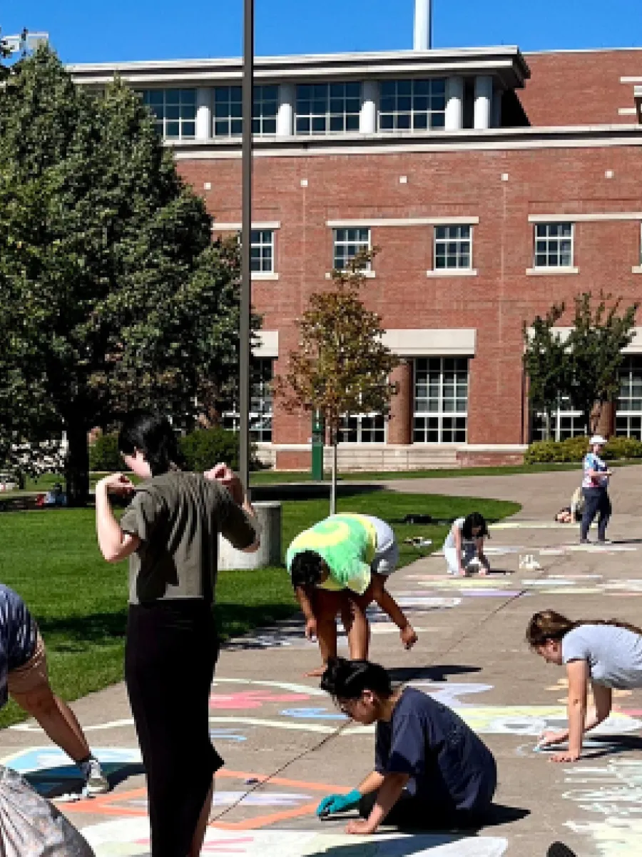 Students participating in the sidewalk chalk competition