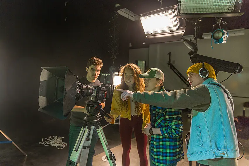Four digital cinema students working in a production lab at Northern Michigan University.