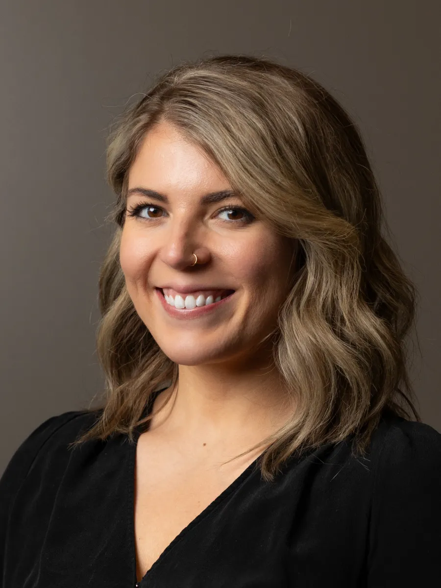 woman in black shirt smiles in headshot