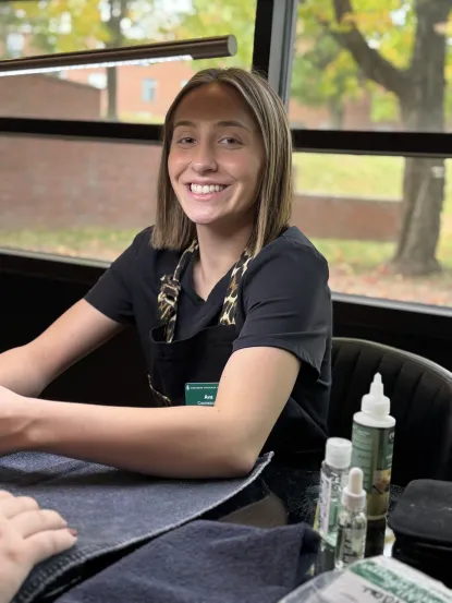 Cosmetology student smiles at camera