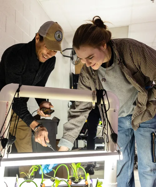 Two students work on student designed system