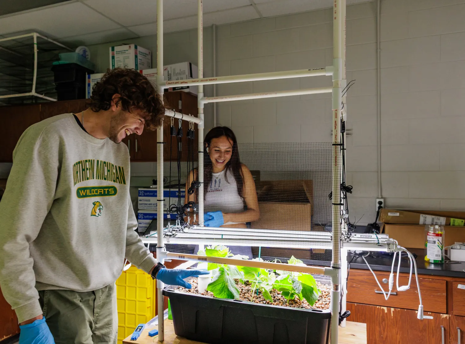 Two students work over student-made system