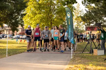 Students gathered in athletic attire at the start line of the Mind over Miles 5k