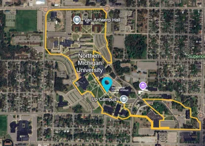 Google Earth view of campus from above, with race route in yellow. A blue location icon indicates the start and finish location of the Wildcat Statue on campus.