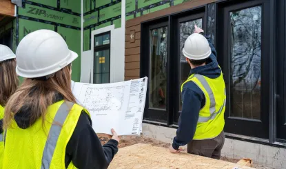 construction students looking at a building plan
